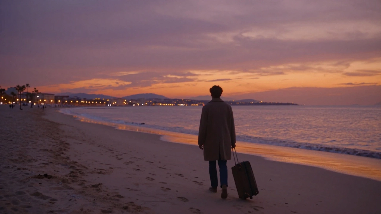 A solitary figure walking along an empty Cannes beach at sunset, suitcase beside them, footprints fading in the sand.